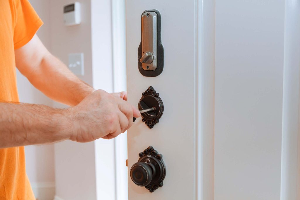 closeup of a professional locksmith installing