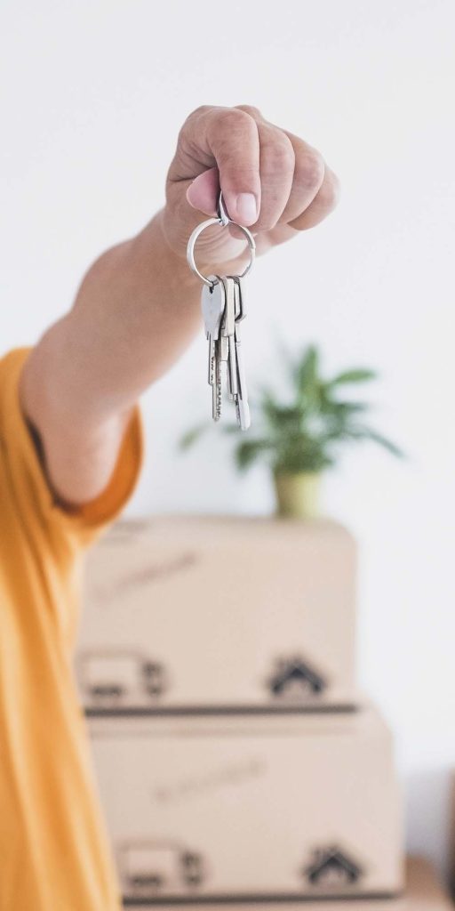 senior happy woman holding keys of the new apartment